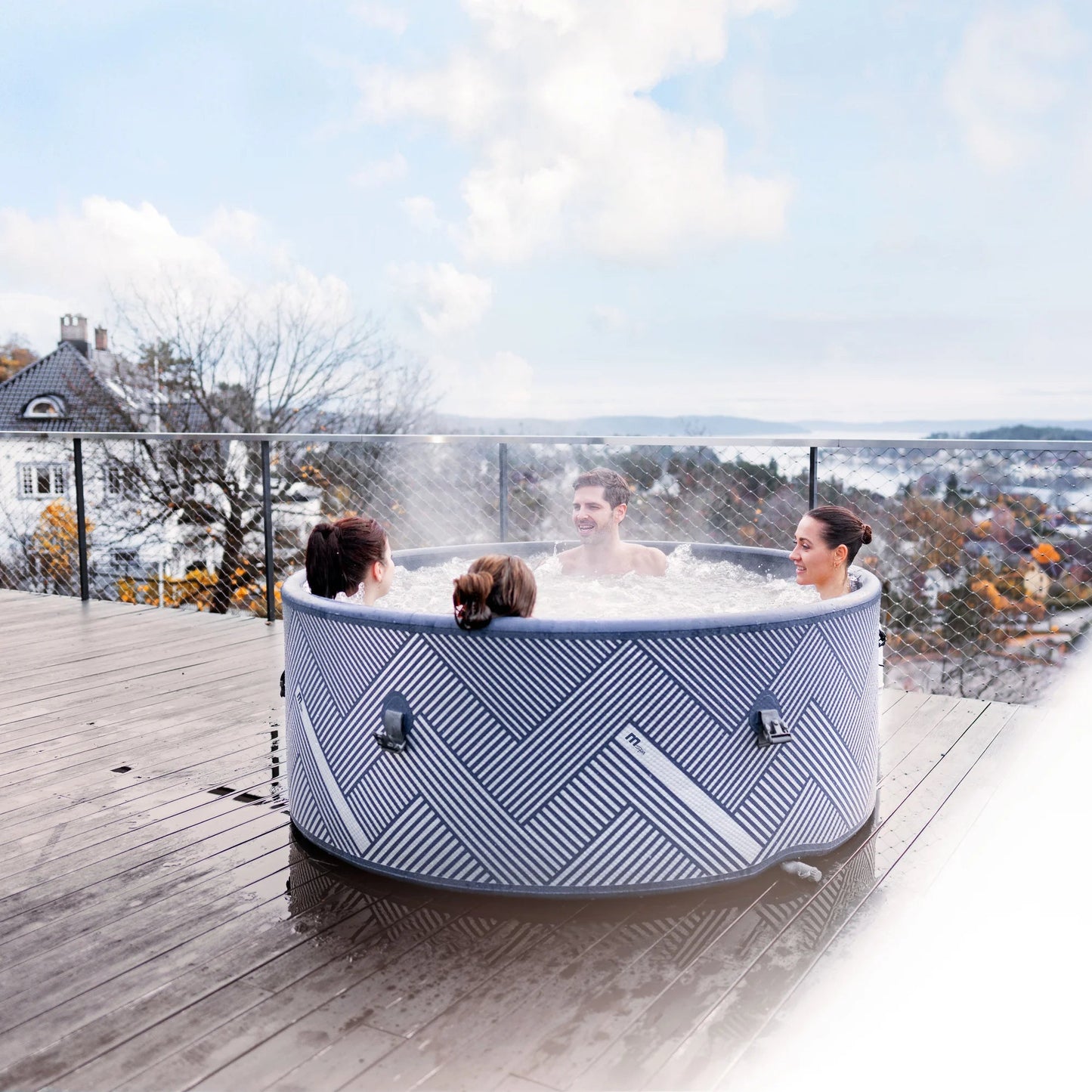 Family in a trendy portable hot tub spa pool on a rooftop with a scenic view of houses and trees - portablespasnz