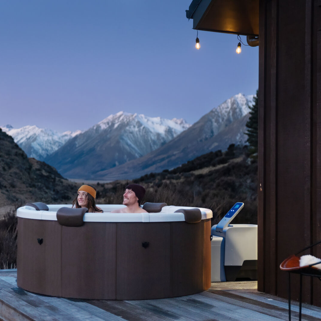 Round solid portable spa surrounded by Alps, South Island NZ.