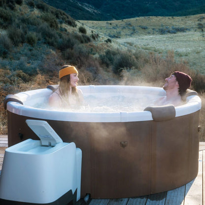 couple in an affordable hot tub surrounded by NZ nature - portablespasnz